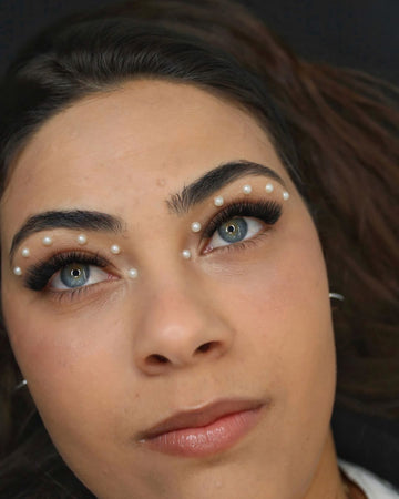 Modelo com extensões de pestanas e pérolas aplicadas junto aos olhos